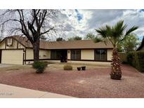 Charming single-story home with a well-manicured front yard and mature trees at 126 S Rita Ln, Chandler, AZ 85226