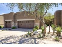 Charming desert home featuring a two car garage with stone accents and drought-resistant landscaping at 13300 E Via Linda -- # 2057, Scottsdale, AZ 85259