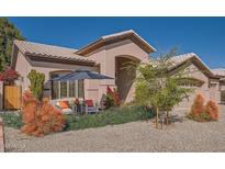 Charming single story home with inviting outdoor seating area and manicured landscaping in front yard at 1966 E Drake Dr, Tempe, AZ 85283