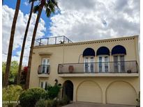 Stunning exterior with balconies, arched garage, and lush landscaping at 2637 E Beekman Pl, Phoenix, AZ 85016