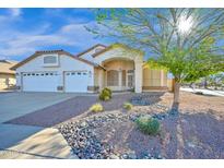 Charming single-story home featuring a well-manicured desert landscape and a spacious three-car garage at 3037 S Coyote Cyn, Mesa, AZ 85212