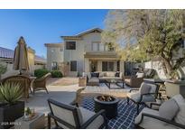 Inviting backyard with outdoor seating, fire pit, and lush landscaping, ideal for relaxing or entertaining at 4033 E Wildcat Dr, Cave Creek, AZ 85331