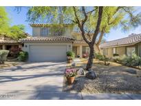 Charming two-story home features a neutral color palette and a well-maintained front yard with desert landscaping at 4033 E Wildcat Dr, Cave Creek, AZ 85331