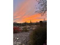 Picturesque desert sunset view from the fenced backyard, showcasing the natural beauty of the area at 41802 N Bridlewood Way, Anthem, AZ 85086