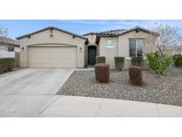 Charming single-story home with neutral stucco, a well-manicured front yard, and a convenient two-car garage at 5428 N 188Th Ln, Litchfield Park, AZ 85340