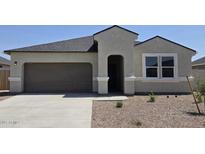 Charming single-story home featuring a two-car garage, neutral stucco, and well-maintained landscaping in a sunny setting at 5735 E Axle Ln, San Tan Valley, AZ 85140