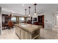 Open kitchen featuring granite countertops, a kitchen island, and an open view to the dining and living spaces at 7175 E Camelback Rd # 1106, Scottsdale, AZ 85251