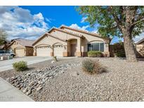 Charming single-story home with a three-car garage and desert landscaping under a sunny, partly cloudy sky at 9174 W Marconi Ave, Peoria, AZ 85382