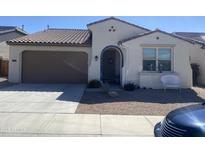 Charming single-story home featuring a tile roof, front yard desert landscaping, and two-car garage at 10739 W Sierra Pinta Dr, Peoria, AZ 85373