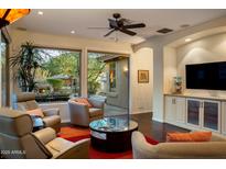 Inviting living room with floor-to-ceiling windows, comfortable seating and outside fireplace views at 11496 E Pine Valley Rd, Scottsdale, AZ 85255