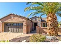 Charming single-story home featuring desert landscaping, a stone facade, and a spacious two-car garage at 13070 W Eagle Talon Trl, Peoria, AZ 85383