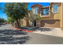 Exterior of a charming two-story home with a private garage and well-maintained landscaping at 14250 W Wigwam Blvd # 1022, Litchfield Park, AZ 85340