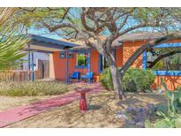 Charming home featuring a covered carport and colorful front patio and drought-tolerant landscaping at 1454 E Flower St, Phoenix, AZ 85014