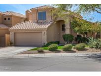 Inviting two-story home boasts a terracotta tile roof, well-manicured landscaping, and an attached two-car garage at 18776 N 90Th Pl, Scottsdale, AZ 85255