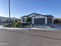 Inviting single Gathering home with a clean, modern elevation, a two-car garage, and desert landscaping at 19864 W San Juan Ave, Litchfield Park, AZ 85340