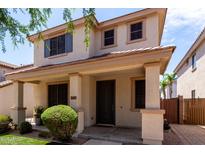 Charming two-story home with a welcoming front porch and well-maintained landscaping at 2116 S Moccasin Trl, Gilbert, AZ 85295