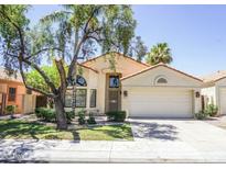 Charming single-story home with a two-car garage, desert landscaping and mature shade trees at 221 E Vaughn Ave, Gilbert, AZ 85234