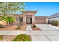 Charming single-story home featuring a well-maintained front yard and a two-car garage at 22800 E Via Las Brisas Rd, Queen Creek, AZ 85142