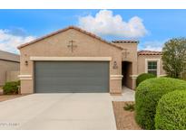 Charming single-story home featuring a grey two-car garage, desert landscaping, and a covered entryway at 2426 E San Gabriel Trl, Casa Grande, AZ 85194