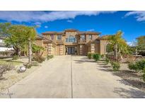 Grand two-story home featuring manicured landscaping, a sprawling driveway, and a symmetrical facade at 2868 E Clifton Ct, Gilbert, AZ 85295