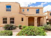 Charming tan two-story home with arched entry and landscaped front yard at 3507 E Erie St, Gilbert, AZ 85295