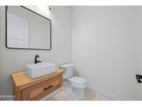 Stylish half bathroom with vessel sink and modern black framed mirror at 4409 N 32Nd St, Phoenix, AZ 85018