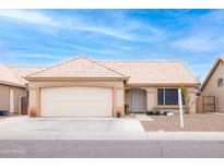 Charming single-story home with a tile roof, desert landscaping and a two-car garage at 473 E Laredo St, Chandler, AZ 85225