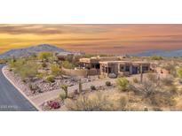 Desert home at sunset, showcasing Southwestern architecture, mature landscaping, and mountain views at 8154 E Tecolote Cir, Scottsdale, AZ 85266