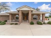 Charming brick home featuring a welcoming front porch and well-maintained landscaping at 1321 W Gardenia Ave, Phoenix, AZ 85021