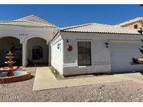 Charming home featuring a well-manicured yard, decorative fountain, and white exterior at 14240 N Ibsen Dr # B, Fountain Hills, AZ 85268