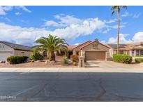 Charming single-story home with a well-maintained yard, desert landscaping, and a spacious driveway at 15850 W Silver Breeze Dr, Surprise, AZ 85374