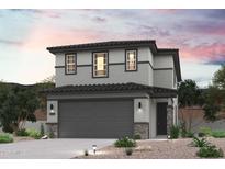 Two-story home featuring stone accents, a two-car garage, and desert landscaping at 17306 W Jessie Ln, Surprise, AZ 85387