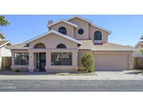 Charming two-story home featuring a unique architectural design and a well-maintained front yard at 18823 N 41St Dr, Glendale, AZ 85308