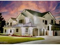 An inviting two-story home with a well-manicured lawn and a two-car garage offering curb appeal at 19450 E Silver Creek Ln, Queen Creek, AZ 85142