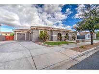 Exterior of home featuring a three car garage and desert landscaping at 21186 E Sunset Dr, Queen Creek, AZ 85142