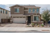 Two-story home featuring a desert landscaped yard, a two-car garage and stone accents at 21512 S 225Th Way, Queen Creek, AZ 85142