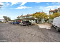 Apartment complex with covered parking showing tidy landscaping, and a view of multiple resident vehicles at 2315 W Union Hills Dr # 119, Phoenix, AZ 85027