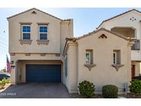 Charming stucco home with a covered driveway, a brick driveway, and an American flag at 285 E Raleigh Dr, Chandler, AZ 85286