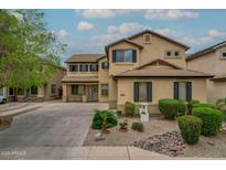 Charming two-story home featuring a neutral color palette, tidy landscaping, and a spacious driveway walkway at 3712 S 104Th Ln, Tolleson, AZ 85353