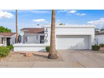 Charming single-story home with stucco exterior, desert landscaping, and a two-car garage at 406 W Fellars Dr, Phoenix, AZ 85023