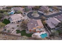 Beautiful aerial view of the home featuring an outdoor pool, patio and fire pit in a desert landscape at 7418 E Sandia Cir, Mesa, AZ 85207