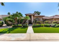 Charming home featuring a tile roof, manicured landscaping, and a welcoming entrance at 8531 E San Lorenzo Dr, Scottsdale, AZ 85258