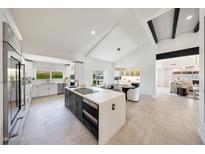 Bright, open kitchen featuring stainless appliances, modern countertops, and a central island at 9675 E Cinnabar Ave, Scottsdale, AZ 85258