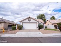 Charming single-story home features a two-car garage, low maintenance yard, and classic desert landscaping at 1502 E Detroit St, Chandler, AZ 85225