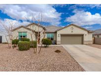 Charming single-story home featuring low maintenance landscaping, a two car garage, and neutral color palette at 17017 N Palo Azul Rd, Maricopa, AZ 85138