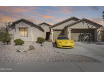 Charming single-story home with a well-manicured desert landscape and an attached two-car garage at 1785 S 222Nd Ln, Buckeye, AZ 85326