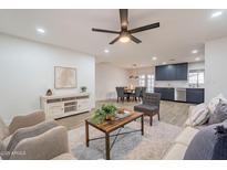 Open-concept living space featuring modern finishes and seamless flow to the dining and kitchen areas at 1816 W Villa Maria Dr, Phoenix, AZ 85023