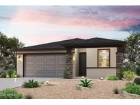 Beautiful single-story home with a two-car garage and desert landscaping at 18243 W Daley Ln, Surprise, AZ 85387
