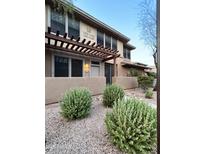 Charming two-story home with a pergola and a well-maintained landscaped front yard at 19777 N 76Th St # 1198, Scottsdale, AZ 85255