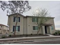 Inviting two-story home with neutral paint, simple landscaping, and charming curb appeal in a peaceful neighborhood at 2315 N 73Rd Dr, Phoenix, AZ 85035